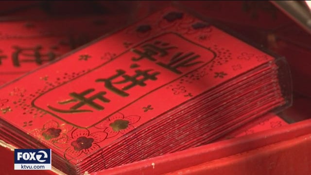 Firecrackers ward off evil spirits, signs of familiar Lunar New Year symbolism prevail