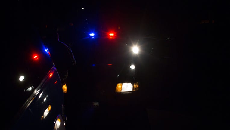 A file image shows lights flashing on a police car during a traffic stop. (Photo credit: Robert Nickelsberg/Getty Images)