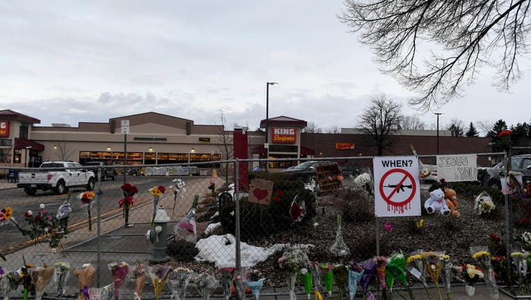 Flowers line an ever-growing memorial along the sidewalk and fence a day after a mass shooting at King Soopers, on March 23, 2021. (Photo by AAron Ontiveroz/MediaNews Group/The Denver Post via Getty Images)