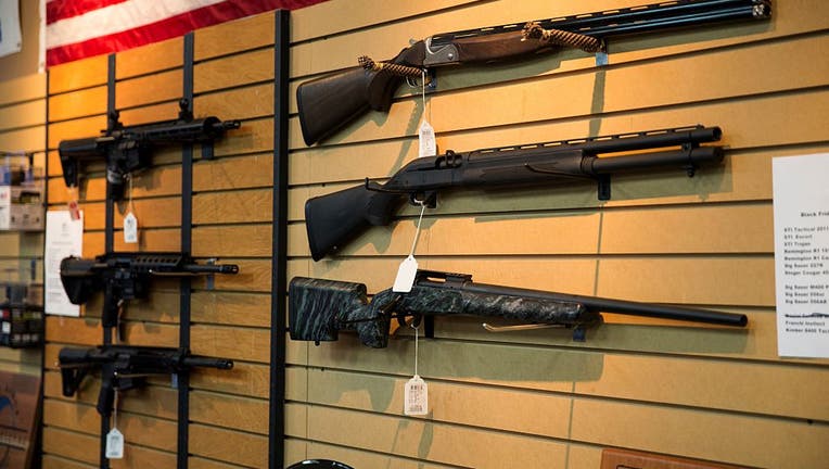 FILE - Shotguns and AR-15 style rifles are seen for sale in Chantilly, Virginia on Jan. 9, 2015. (Photo by Samuel Corum/Anadolu Agency/Getty Images)