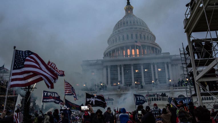 FILE - Security forces respond with tear gas after the US President Donald Trump's supporters breached the US Capitol security.