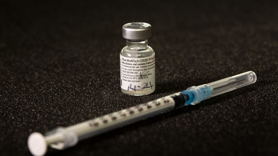 FILE - A vial of the Pfizer-BioNTech COVID-19 vaccine and syringe is shown in a file image dated March 11, 2021. (Photo by Victoria Jones/PA Images via Getty Images)