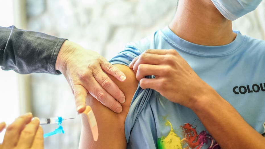 A young man receives his Covid-19 vaccination at a