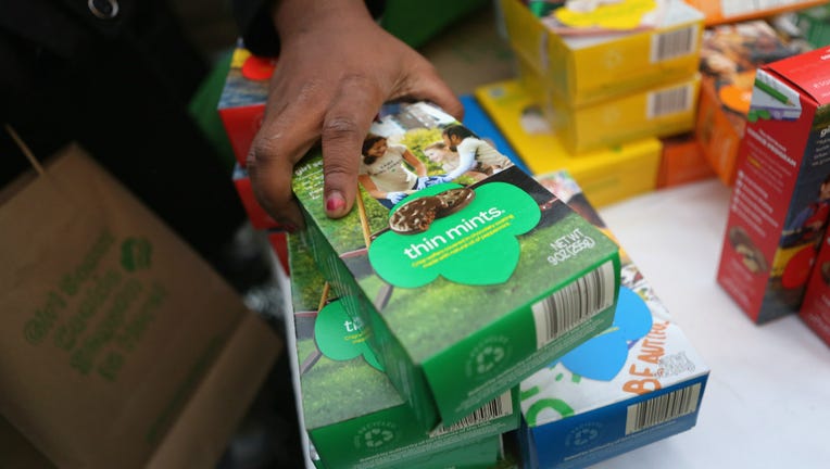 82632234-Girl Scouts sell cookies.