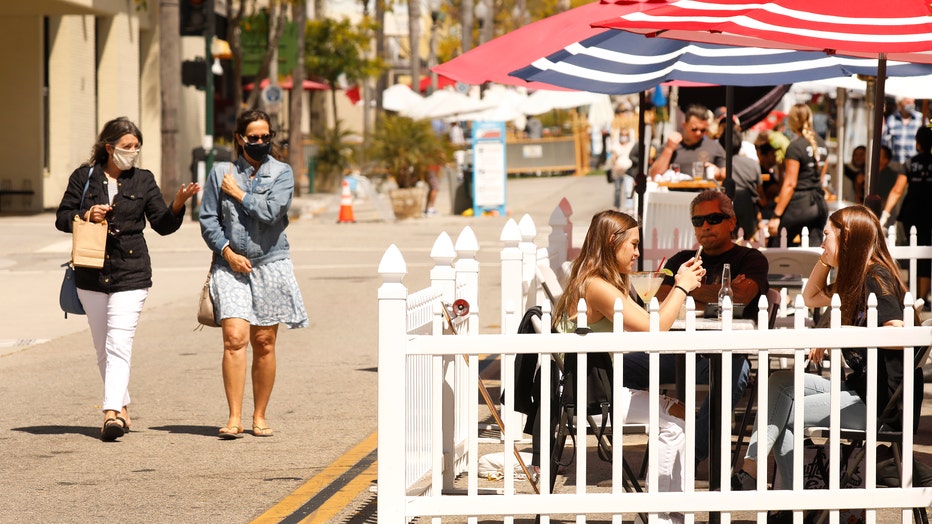 d1d5e66d-Pedestrians are required to wear a mask and practice social distancing when visiting Main Street in downtown Ventura which has been closed to vehicle traffic to allow restaurants and businesses to accommodate for outdoor activity in the era of the Covid-19