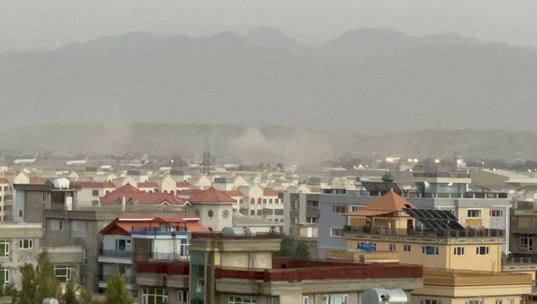 Smoke rises after two explosions reported outside Hamid Karzai International Airport, the center of evacuation efforts from Afghanistan since the Taliban took over in Kabul, Afghanistan on Aug. 26, 2021. (Photo by Haroon Sabawoon/Anadolu Agency via Getty Images)