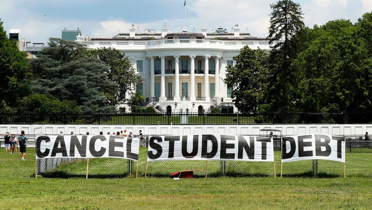 As college students around the country graduate with a massive amount of debt, advocates display a hand-painted sign on the Ellipse in front of The White House to call on President Joe Biden to sign an executive order to cancel student debt on June 15, 2021, in Washington, DC. (Photo by Paul Morigi/Getty Images for We The 45 Million)