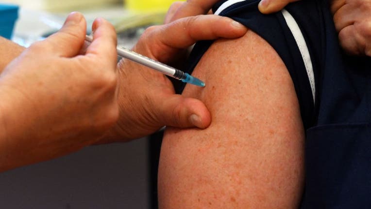FILE - A nurse administers a dose of a Pfizer booster vaccine at a vaccination center in Derby, England on Sept. 20, 2021.(Photo by PAUL ELLIS/AFP via Getty Images)