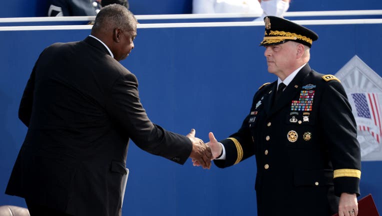 FILE - Secretary of Defense Lloyd Austin (L) shakes hands with Chairman of the Joint Chiefs of Staff Gen. Mark A. Milley during the Pentagon 9/11 observance ceremony at the National 9/11 Pentagon Memorial on Sept. 11, 2021, in Arlington, Virginia. (Photo by Win McNamee/Getty Images)