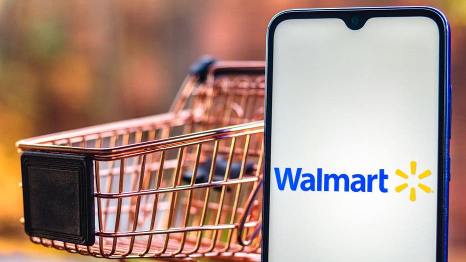 In this photo illustration, a Walmart logo seen displayed on