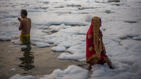 Hindus take holy dip in sacred Yamuna River despite toxic foam