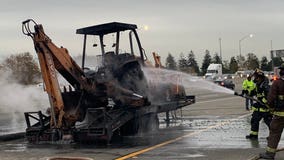 Backhoe catches fire on Oakland freeway