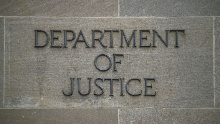 FILE - A "Department of Justice" sign is seen on the wall of the US Department of Justice building in Washington, D.C. on April 18, 2019. (Photo by CHANDAN KHANNA/AFP via Getty Images)