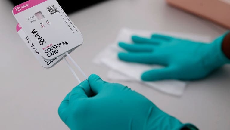 FILE - A health worker handles COVID-19 rapid tests at a testing site in Oakland, Calif., on April 29, 2021. (Jane Tyska/Digital First Media/East Bay Times via Getty Images)