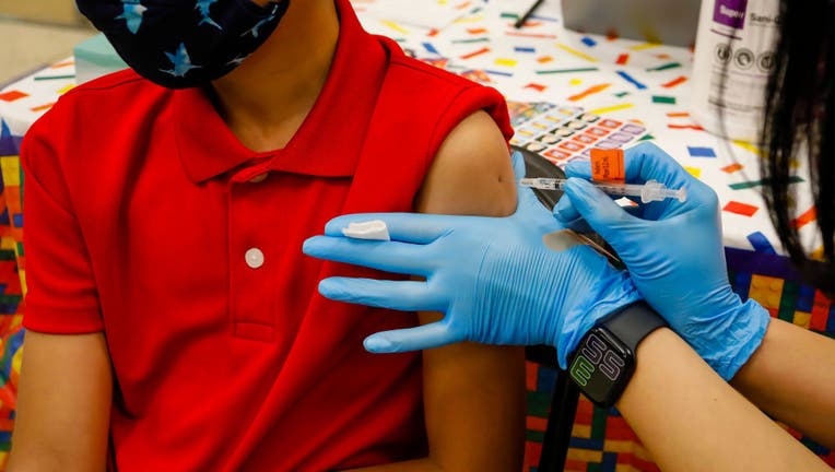 FILE - A child receives a dose of the Pfizer-BioNTech COVID-19 vaccine at an elementary school vaccination site for children ages 5 to 11-year-old in Miami, Florida, on Nov. 22, 2021. Photographer: Eva Marie Uzcategui/Bloomberg via Getty Images