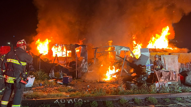 Raging West Oakland fire burns through homeless encampment
