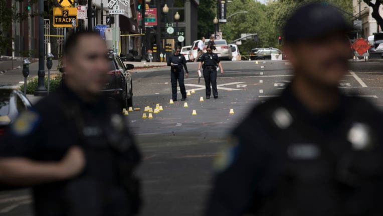 Police officers work at the scene of a mass shooting on April 3, 2022, in Sacramento, California. (Photo by Liu Guanguan/China News Service via Getty Images)