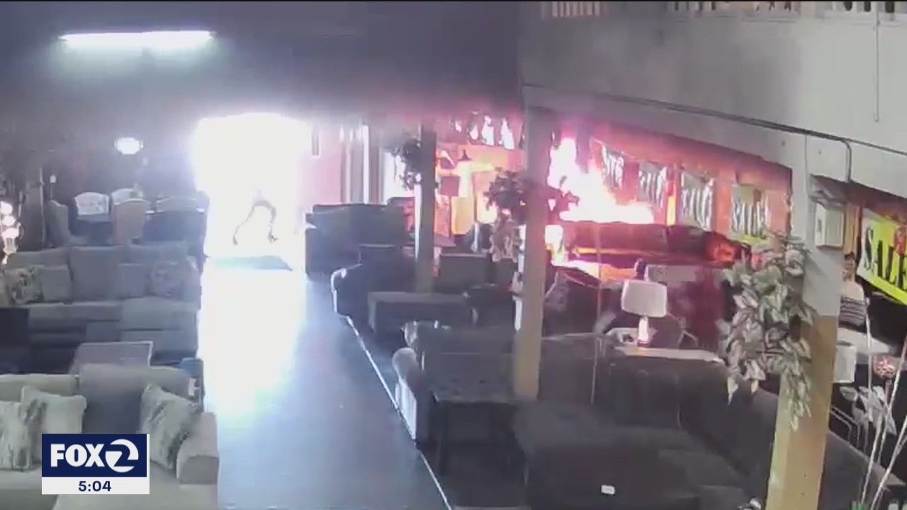 Surveillance video displays guy environment Oakland furniture retail store on fireplace