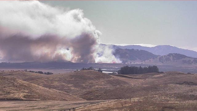 Grass fire near landfill that caused heavy traffic delays on Hwy 101 contained
