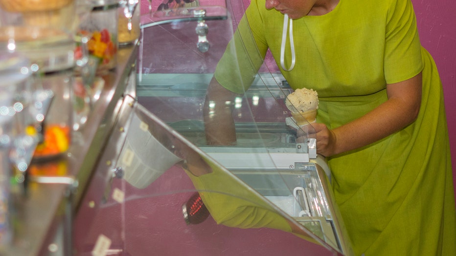 An Amish woman serving ice cream at Big Olaf Creamery.