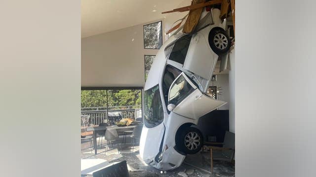 Car slams through garage, lands in kitchen: Oakland Firefighters
