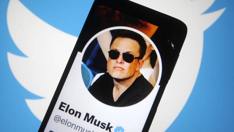 FILE - In this photo illustration, the Twitter account of Elon Musk is seen on a smartphone screen, and the Twitter logo in the background. (Photo Illustration by Pavlo Gonchar/SOPA Images/LightRocket via Getty Images)