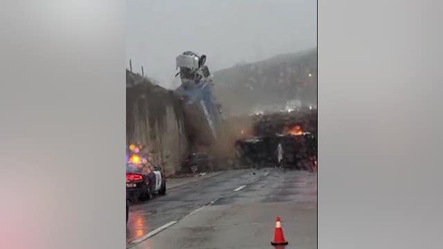 Dramatic video captures truck toppling over California freeway overpass