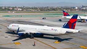 Police: passenger pulled jet’s emergency slide at LA airport