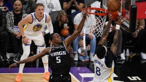 Fox leads Kings past Warriors 126-123 in playoff return