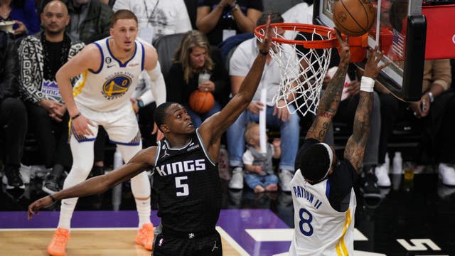 Fox leads Kings past Warriors 126-123 in playoff return