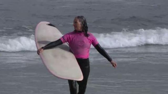‘The competition is pretty high’: Surfers 40 and older showcase their skills at Linda Mar Beach  