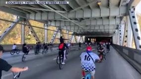 Large group of young bicyclists takeover Bay Bridge