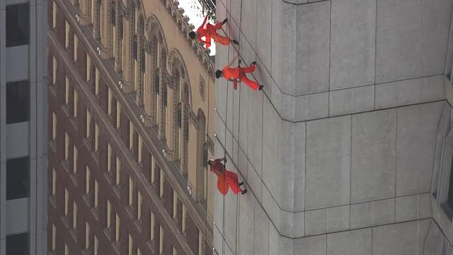 Dance troupe performs on side of Transamerica Pyramid