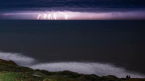 Stunning lightning flashes across purple sky in Pacifica