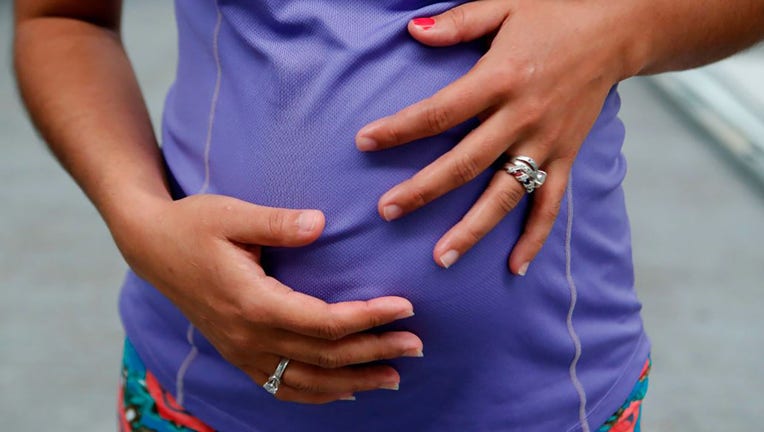woman holds her four-month pregnant belly in a file image dated Aug. 10, 2018. (Photo: ULISES RUIZ/AF