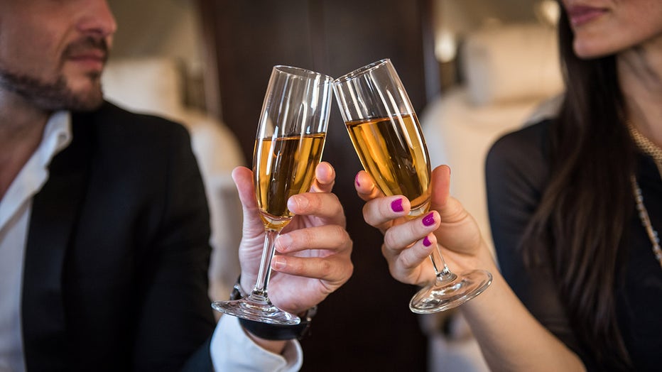 File: Champagne glasses toast in first class