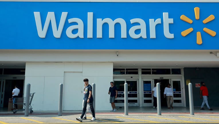 FILE - People walk near the entrance to a Walmart store on May 14, 2024, in Miami, Florida. (Photo by Joe Raedle/Getty Images)
