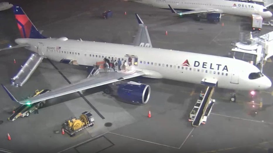 photo showing passengers exit plane over wings
