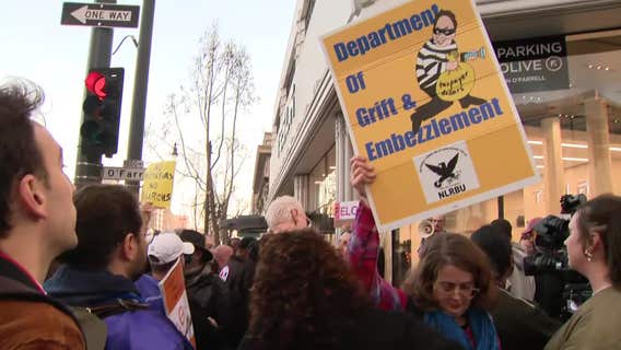 Federal workers protest outside Tesla showroom in San Francisco; Musk defends cuts