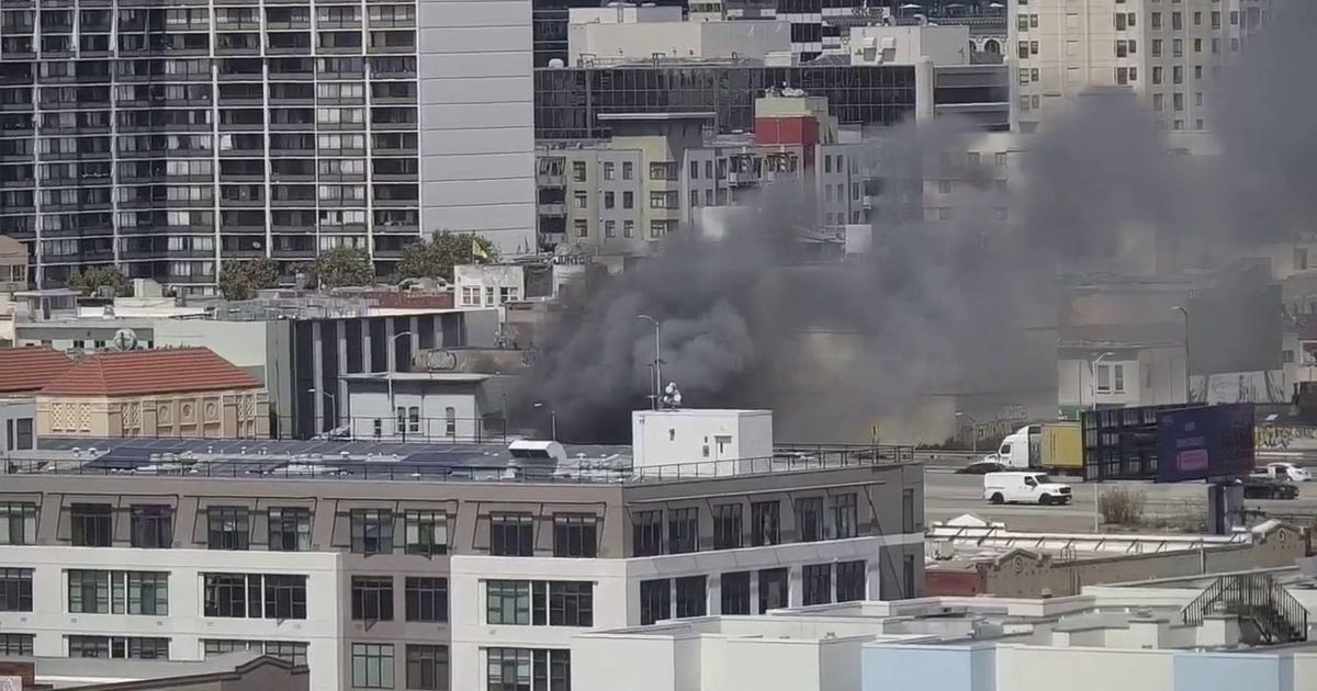 Firefighters douse flames at burning building in Oakland, near Webster and 6th streets