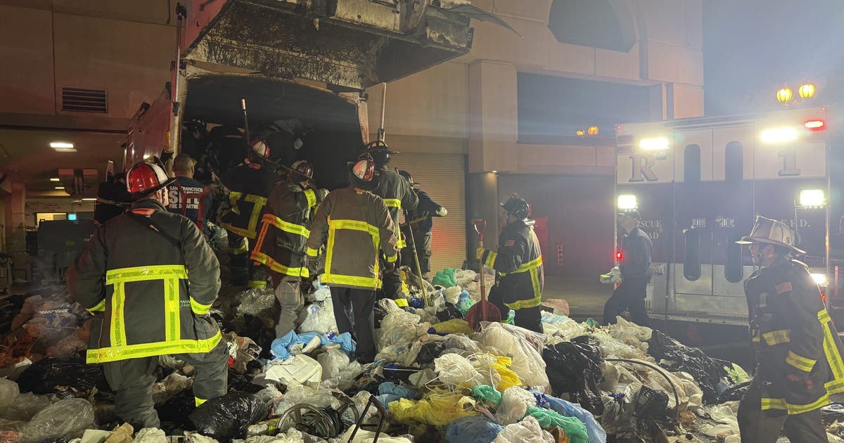 San Francisco Firefighters rescue man trapped in garbage truck