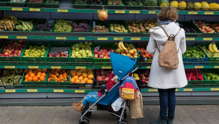 Mother Buys Fruit For Child