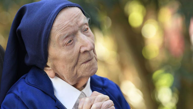 Sister Andre, Lucile Randon in the registry of birth, the eldest French and European citizen, prays in a wheelchair, on the eve of her 117th birthday. (Photo by NICOLAS TUCAT/AFP via Getty Images)