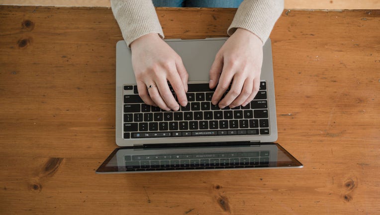 FILE IMAGE - A person types on a laptop computer in a file image dated April 12, 2022. (Photo by Tristan Spinski for The Washington Post via Getty Images)