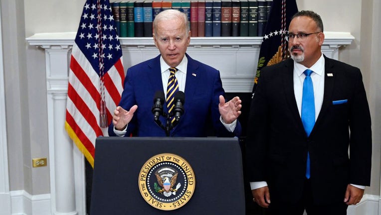 FILE - U.S. President Joe Biden announces student loan relief with Education Secretary Miguel Cardona (R) on Aug. 24, 2022, in the Roosevelt Room of the White House in Washington, D.C. (Photo by OLIVIER DOULIERY/AFP via Getty Images)