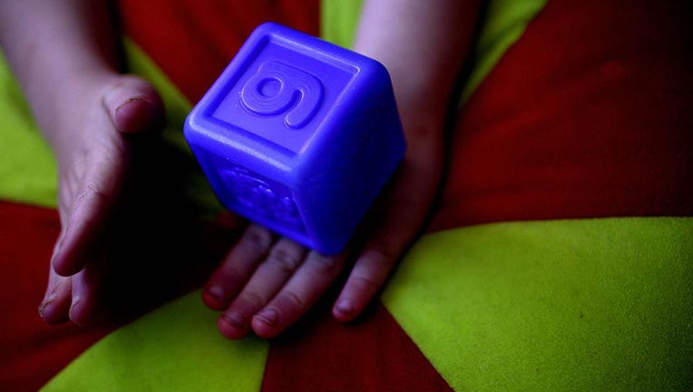A child holds a block in a file image. (Photo by Fairfax Media via Getty Images via Getty Images)