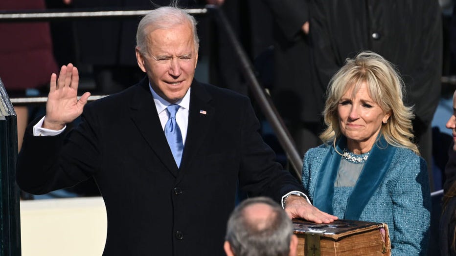  US President-elect Joe Biden is sworn in as his wife Jill Biden holds the Bible during the Presidential Inauguration at the U.S. Capitol on Jan. 20, 2021, in Washington, D.C. (Photo by Saul Loeb - Pool/Getty Images)