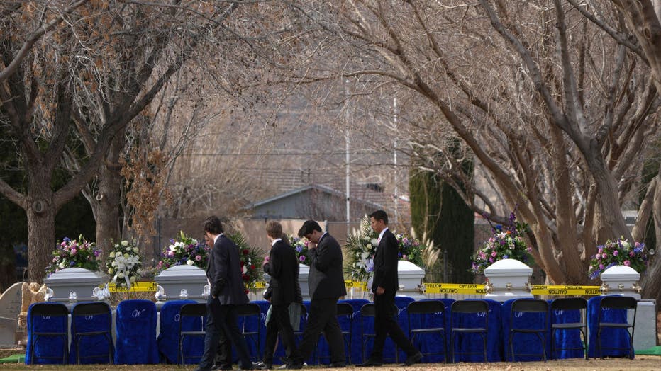 With six of seven caskets lined up friends and relatives of the Haight family pay their last respects on Jan. 13, 2023, in La Verkin, Utah. (Photo by George Frey/Getty Images)
