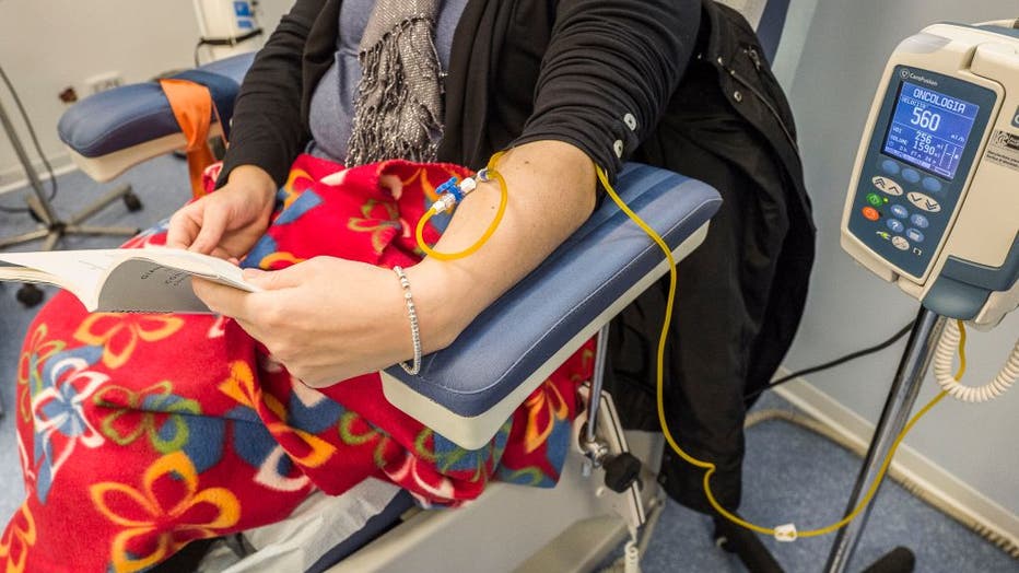 FILE - A detail of the arm of a female cancer patient while reading a book during a chemotherapy session on Nov. 24, 2020. (Photo by Fabrizio Villa/Getty Images)