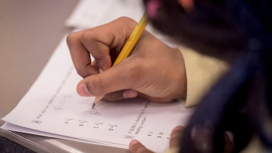 FILE - Photo of a child writing on test booklet during a Common Core math test, grade 4, in Roosevelt, New York, on April 13, 2016. (Photo by J. Conrad Williams, Jr./Newsday RM via Getty Images)